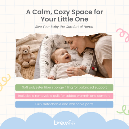Baby lying in grey star-print baby lounger with parent leaning close and smiling, viewed from the side.