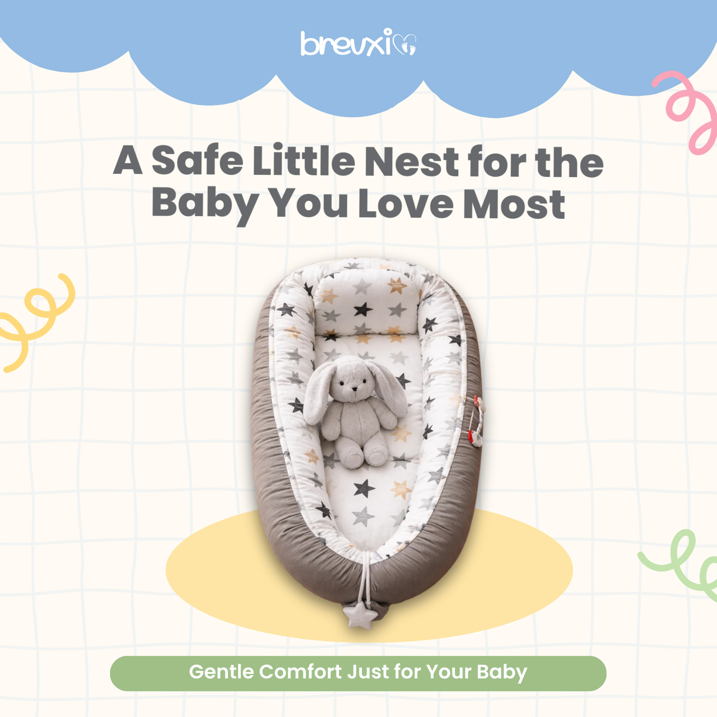 Grey baby lounger with star pattern and plush bunny toy placed in the center, viewed from above.