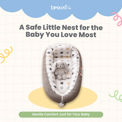 Grey baby lounger with star pattern and plush bunny toy placed in the center, viewed from above.