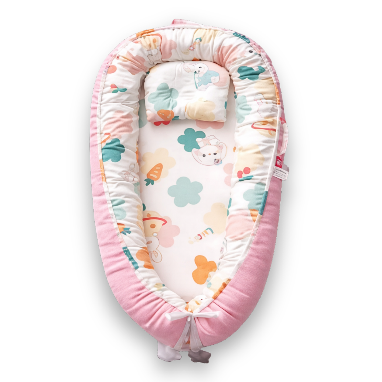 Pink baby lounger with colorful animal and clover print on white interior, viewed from above.