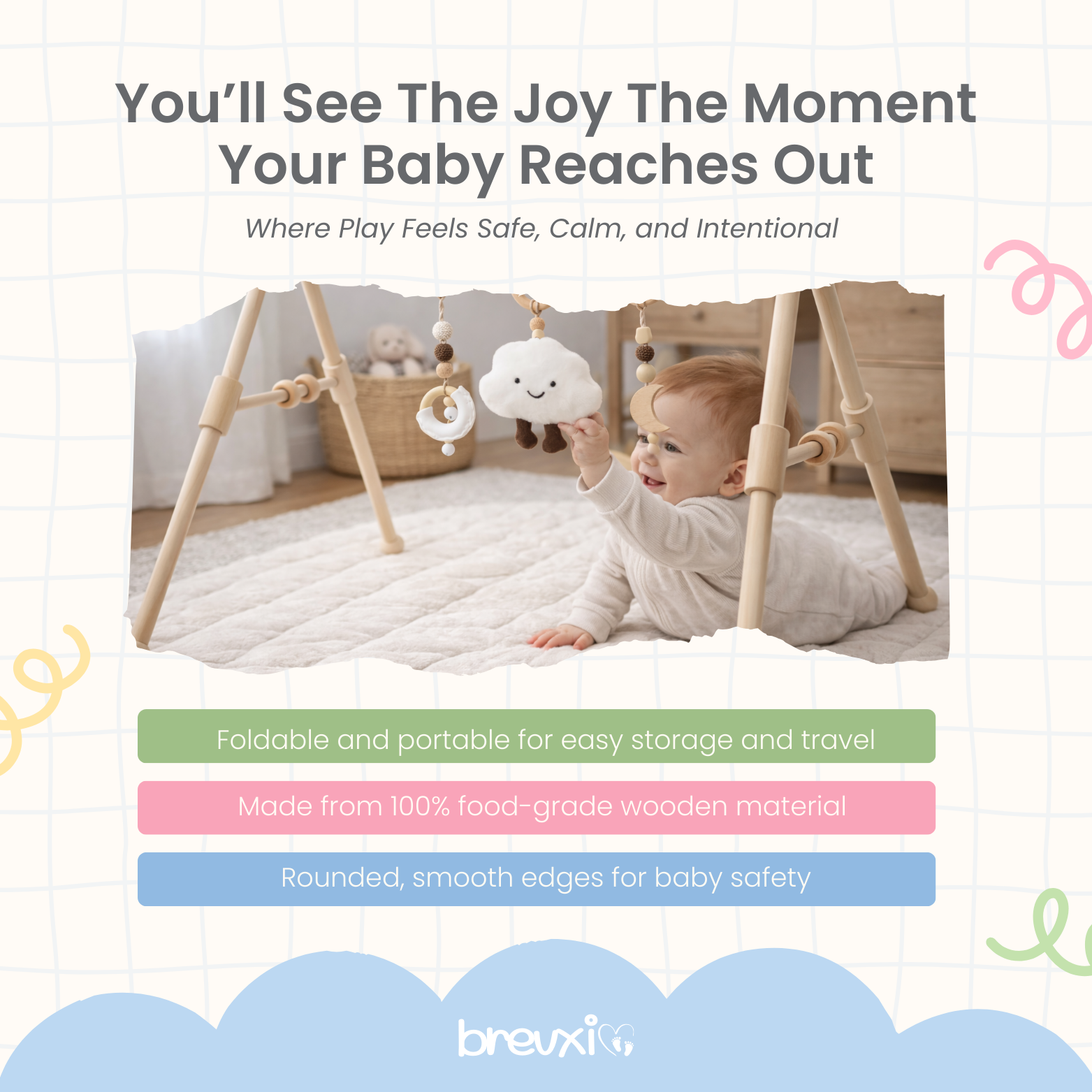 Baby lying on a soft mat reaching for cloud toy hanging from a wooden baby gym frame.