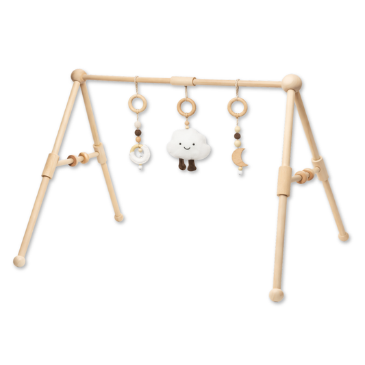 Wooden baby gym with three hanging toys including a soft cloud, moon, and beaded rings.